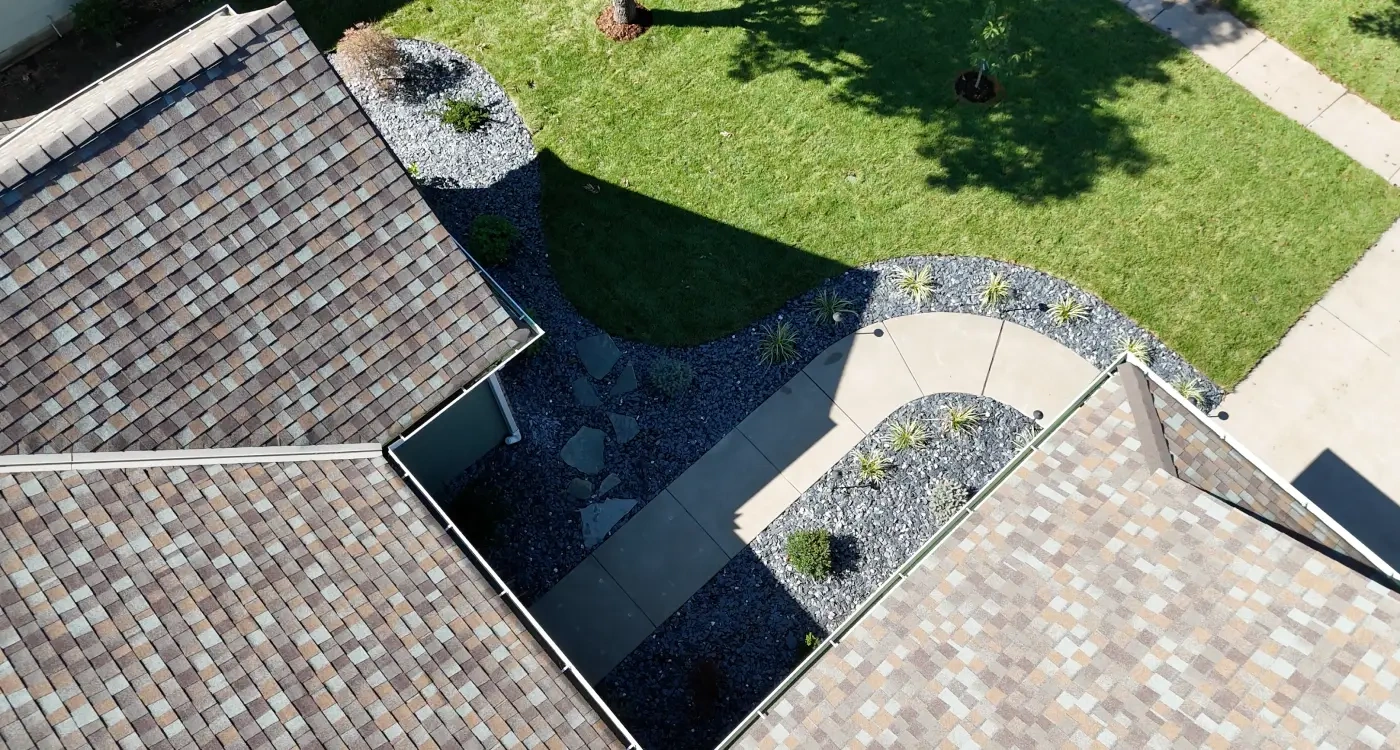 Aerial view of the finished Kumar Residence front landscape, with curved decorative rock beds edged in aluminium and a new walkway.