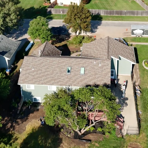 The Kumar house from directly above with the rebuilt beds around it, the new fence line and the neighbours' roofs beyond.